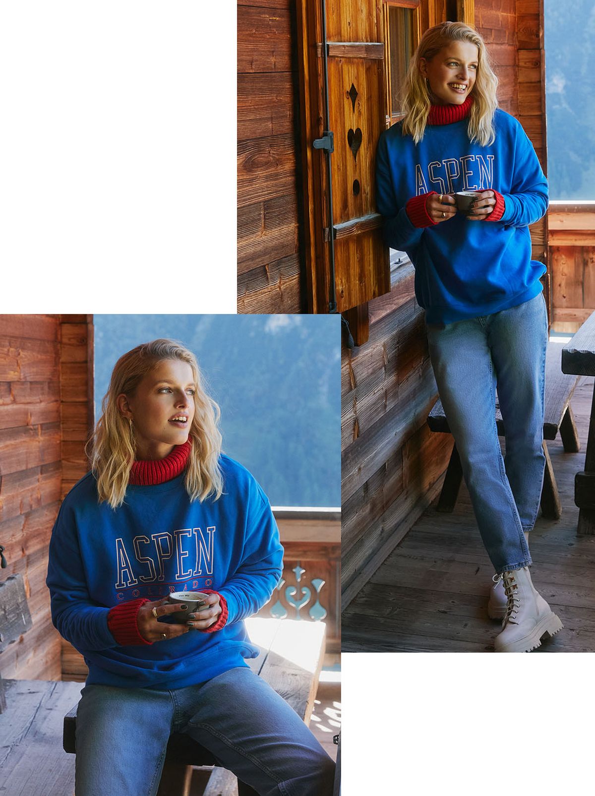 A model leans on the wall of a log cabin, smiling looking away from the camera with a mountain behind her, wearing a blue aspen jumper and a pair of light blue jeans