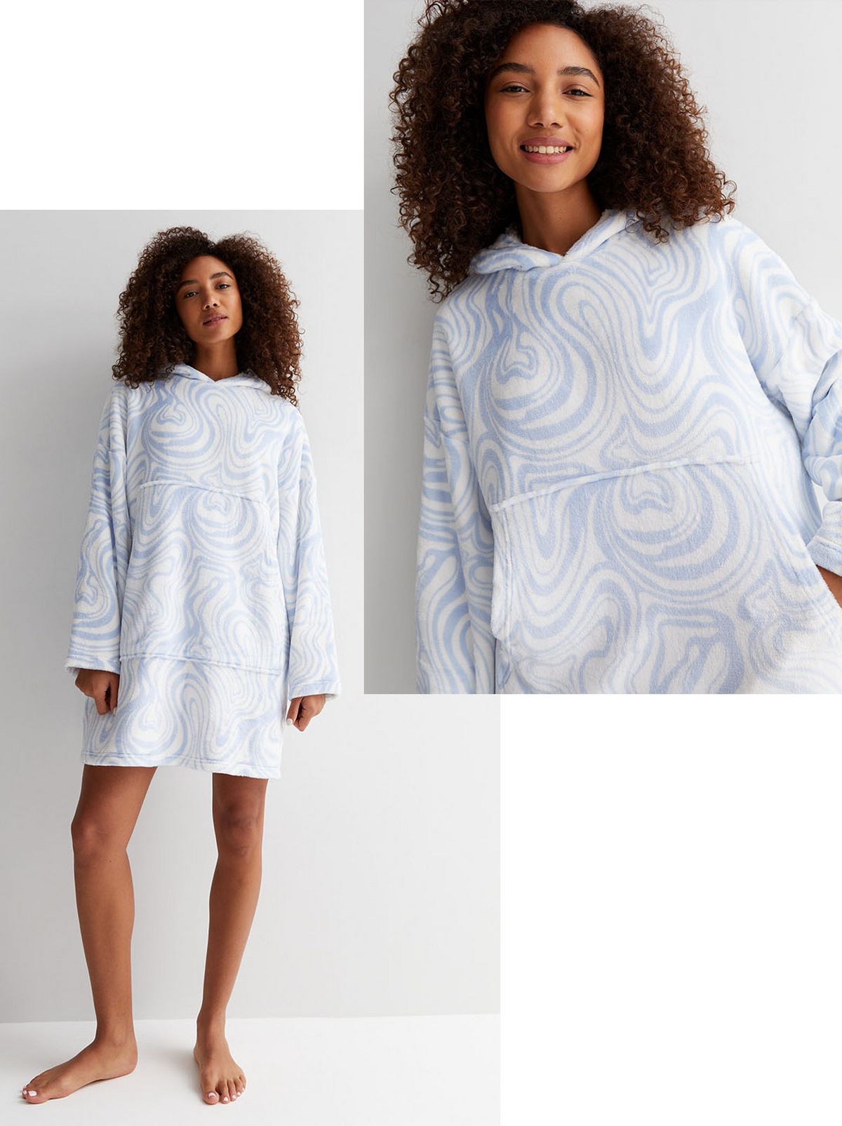 A model smiles at the camera, wearing a blue swirl fleece blanket hoodie with a hand in her pocket