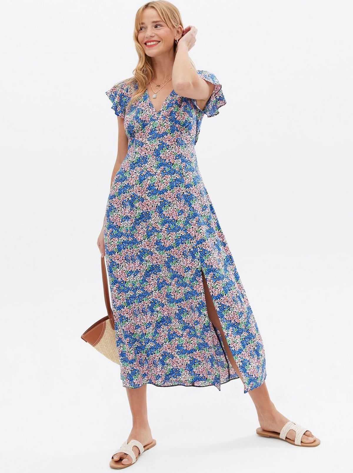 Woman wearing an off white floral mini smock dress