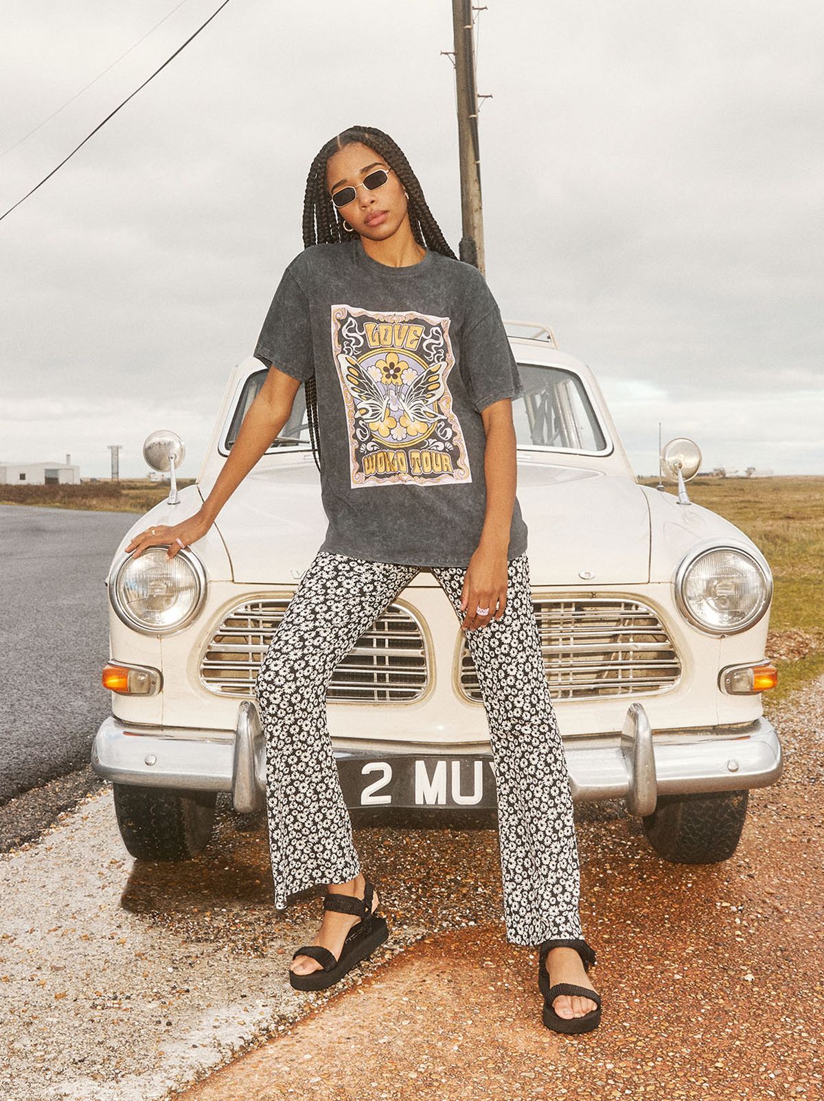 Woman wearing animal print pants and a grey shirt