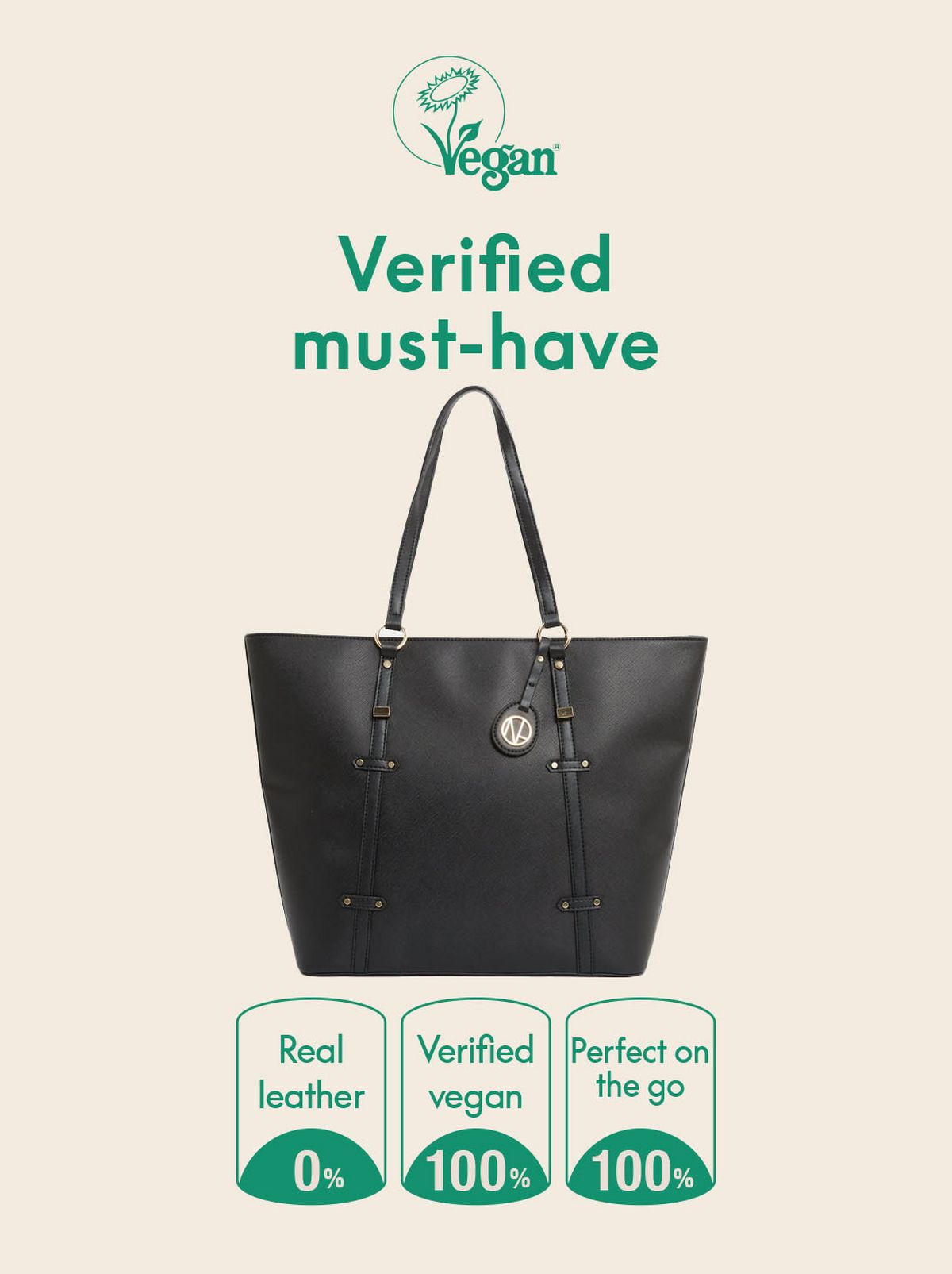 A person is facing away from the camera and looking over their shoulder in front of a white background, they are wearing a white shift, a pair of black trousers and over their shoulder is a black leather look tote bag