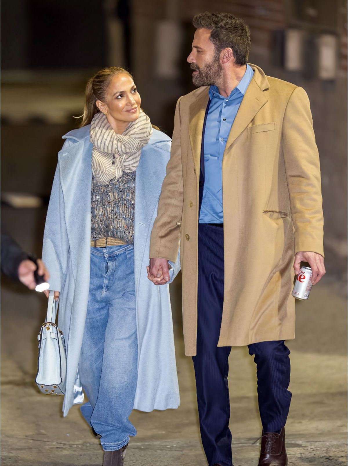 Jennifer Lopez wearing a faux fur coat paired with wide leg blue jeans