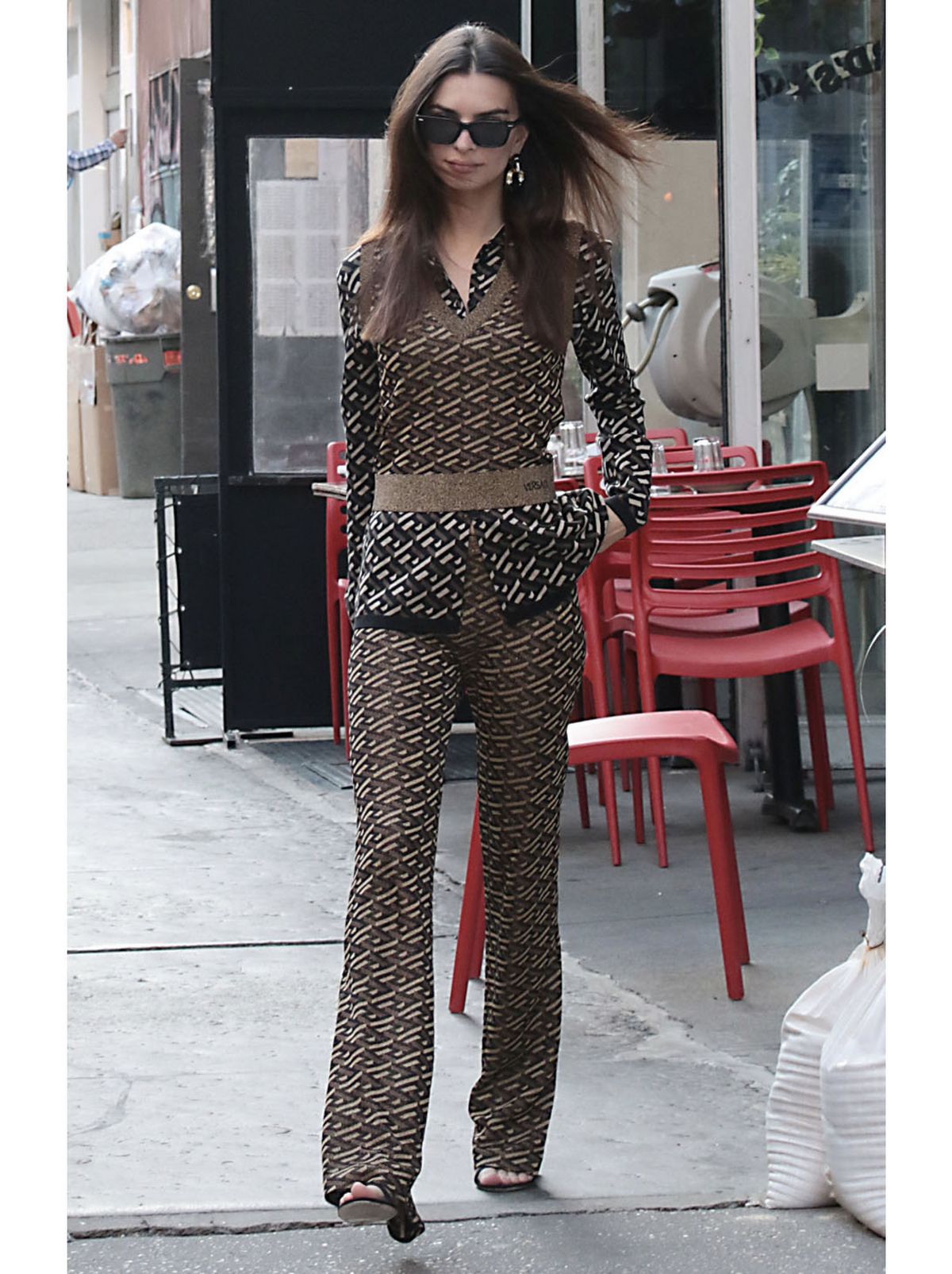 Emily Ratajkowski wearing a geometric collared top and geometric flared trousers