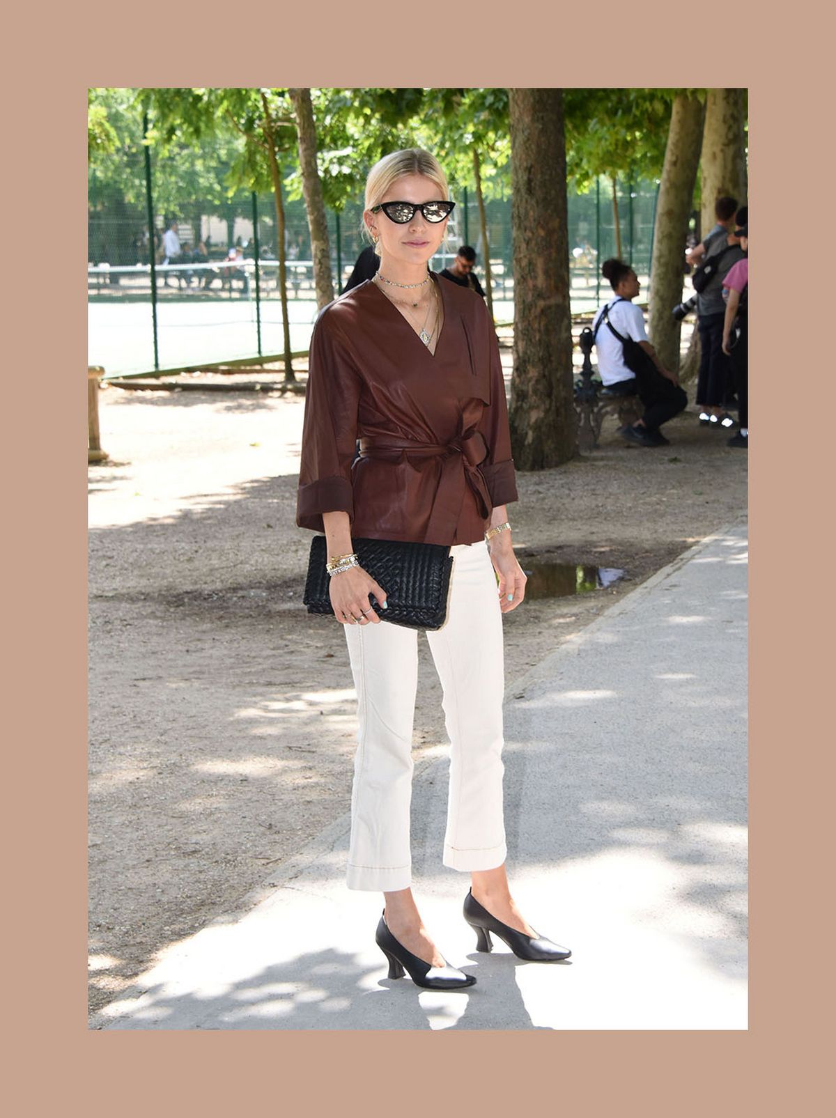 Caroline Daur wearing a brown plunge neck blouse