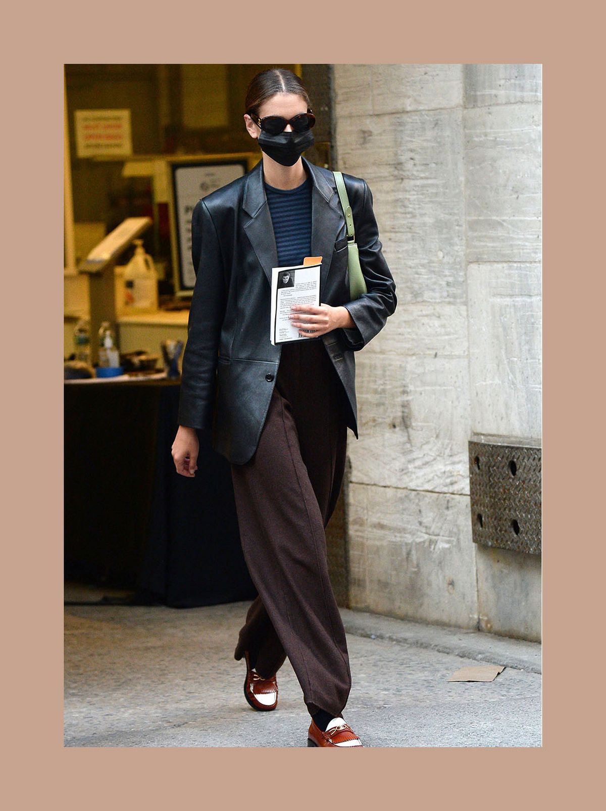 Kaia Gerber wearing brown large flared pants