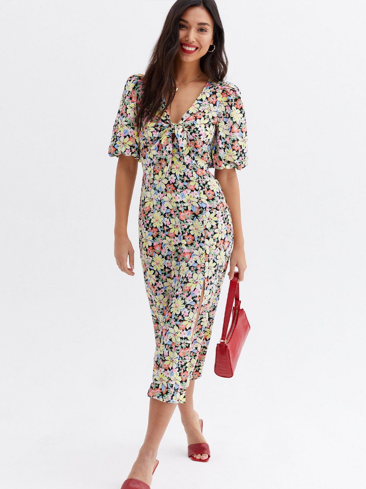 Woman wearing a yellow floral split midi dress