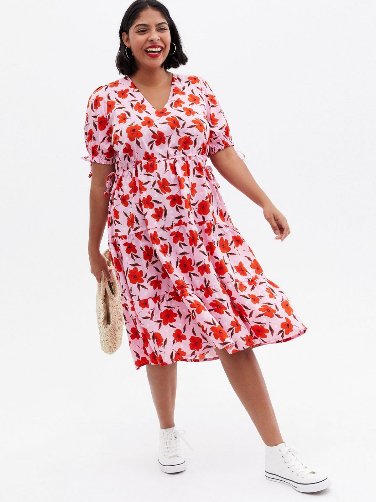 Woman wearing a pink floral smock dress