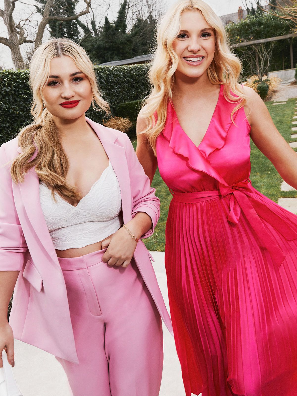 Women wearing a pink suit and bright pink midi dress