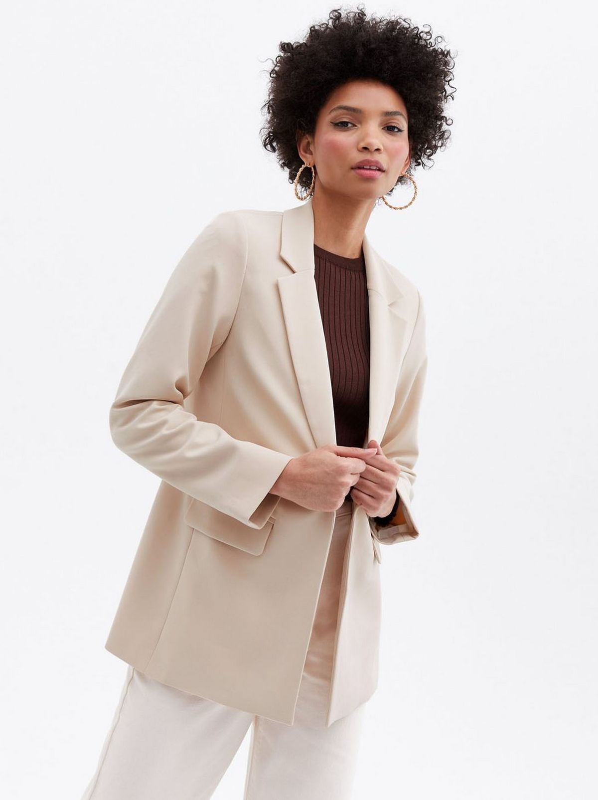 Woman wearing a stone relaxed fit blazer