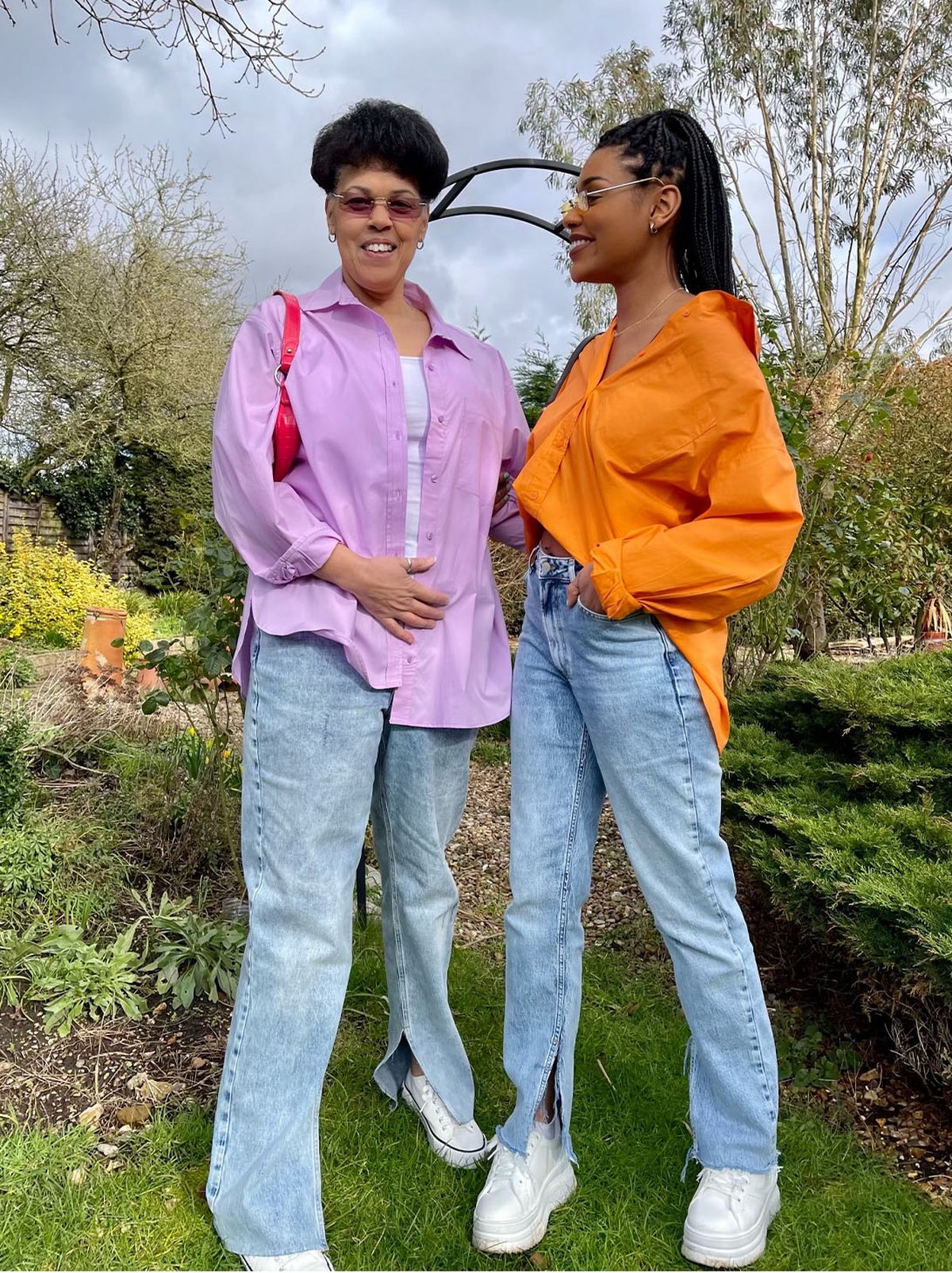 Jasmine and her mother wearing jeans and oversized shirts	