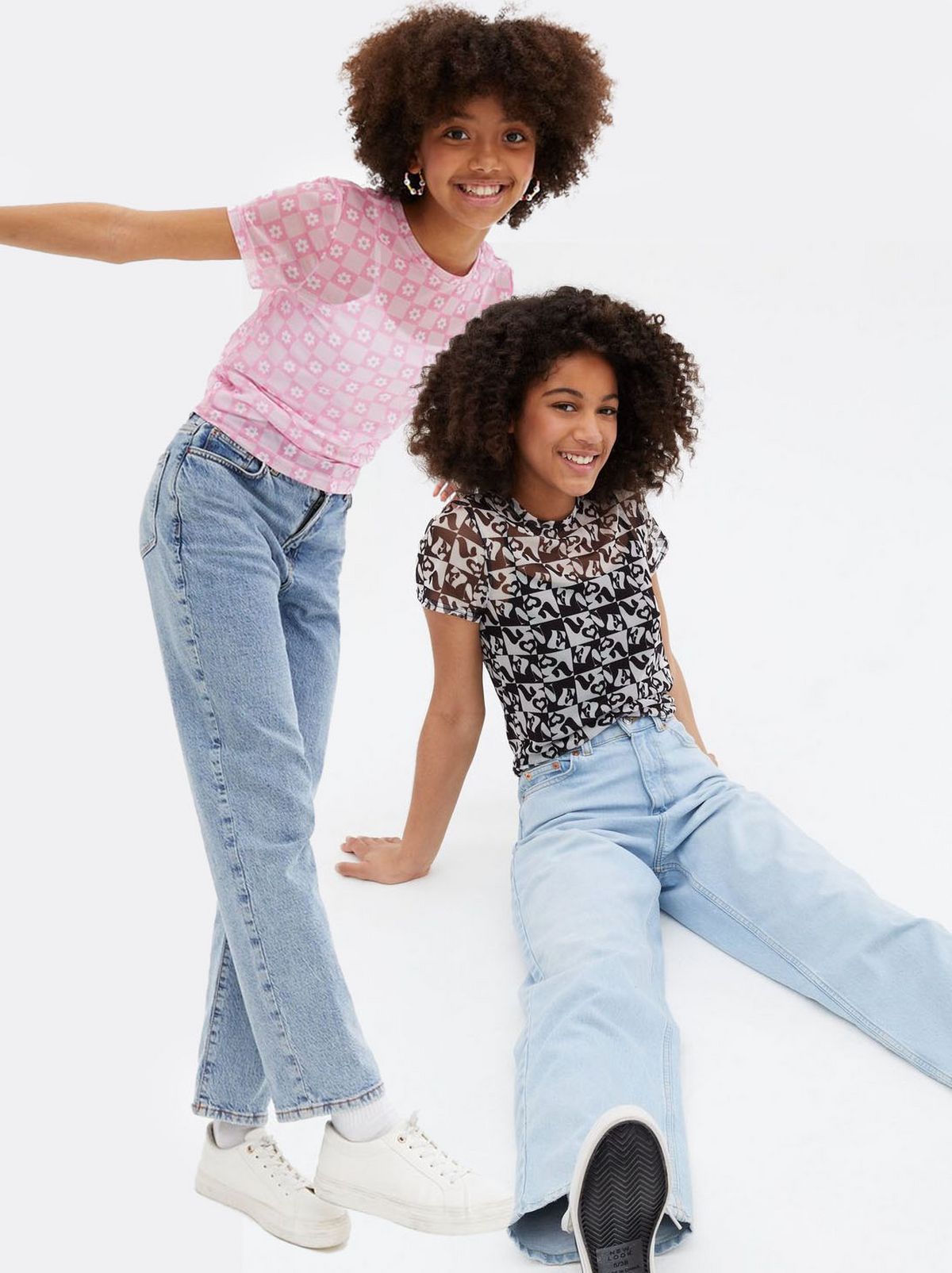 Girl wearing a pink floral mesh t shirt, Girl wearing a black check love mesh logo t shirt