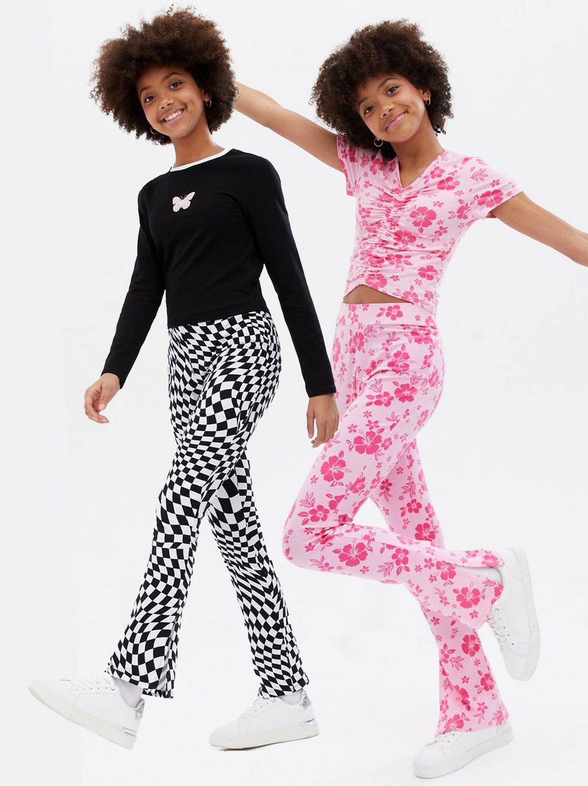 Girl wearing a pink floral t shirt and pants co ord set, Girl wearing a black top and checkboard fitted pants