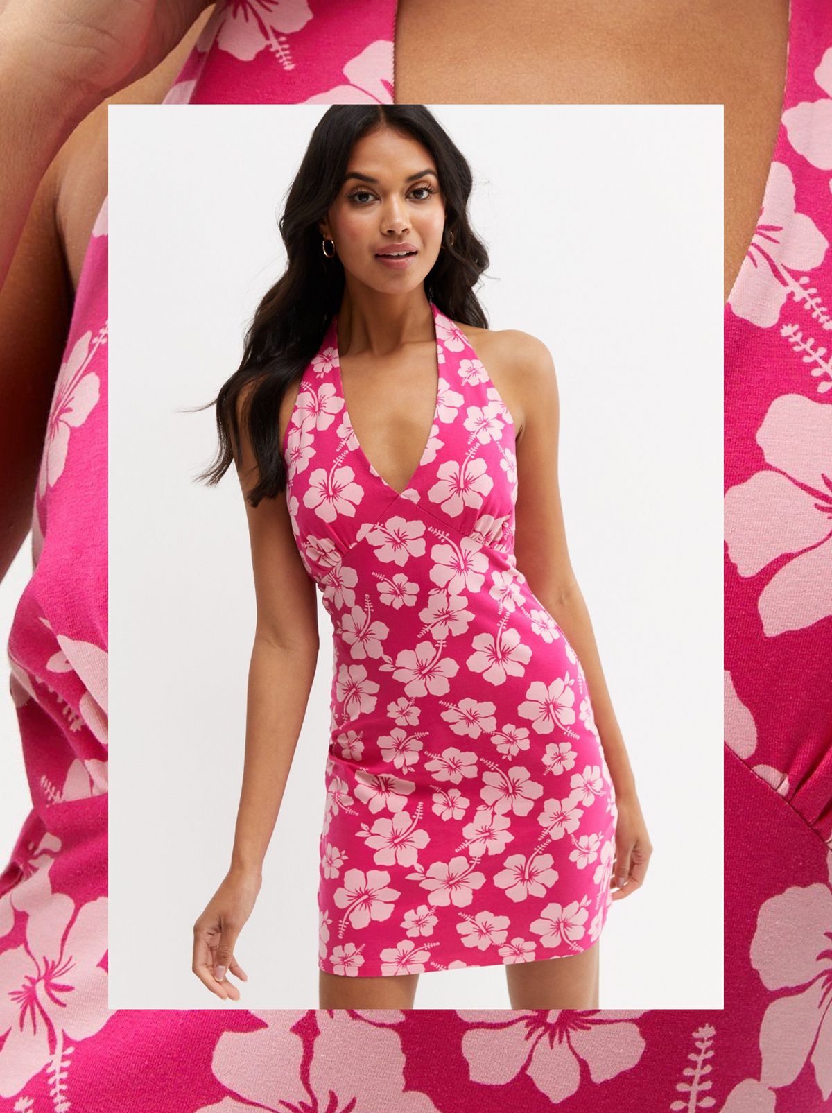 A women stands in front of a white background wearing a pink floral mini dress