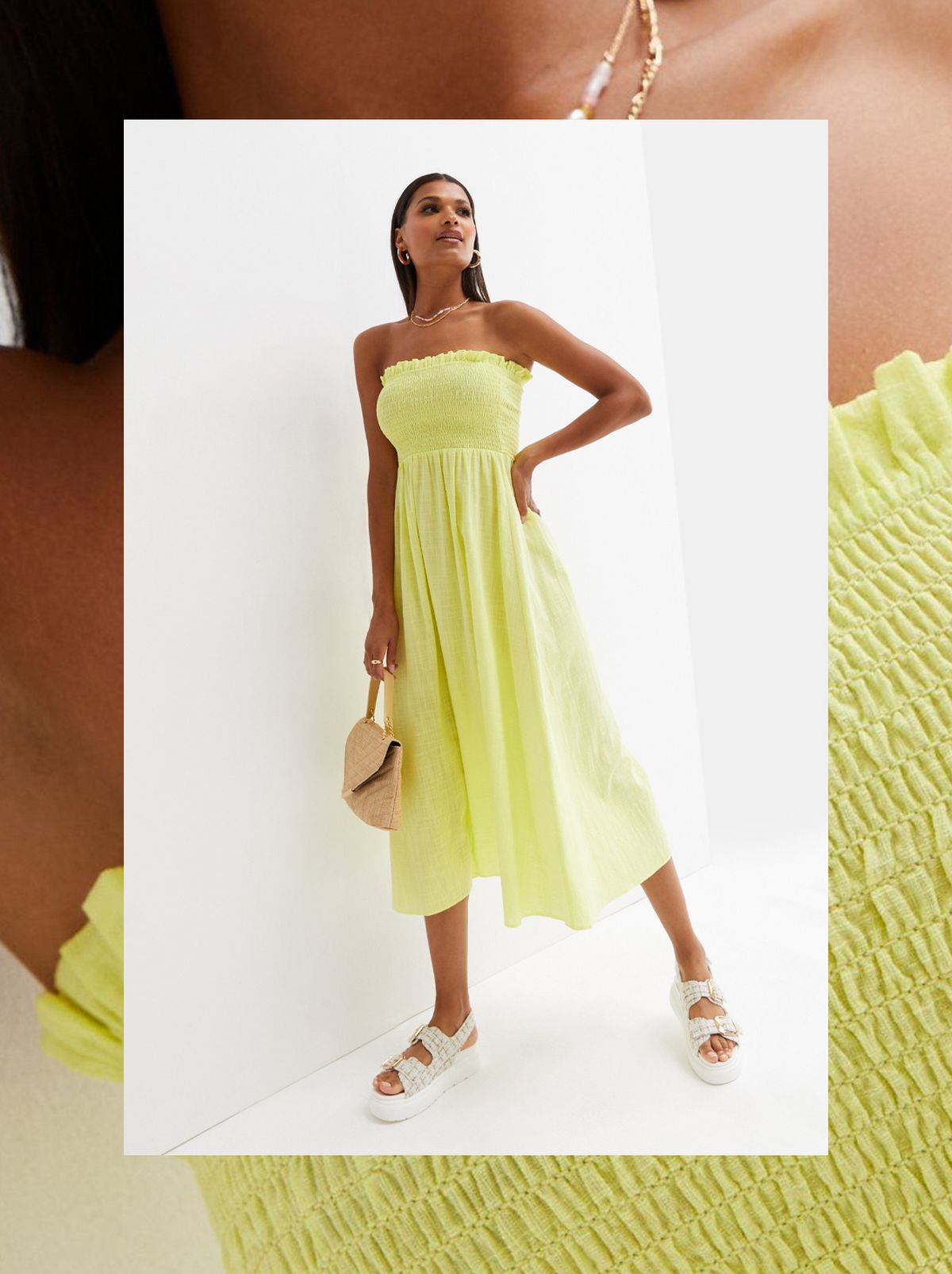 A women stands looking up away from the camera wearing a light green frill mini dress