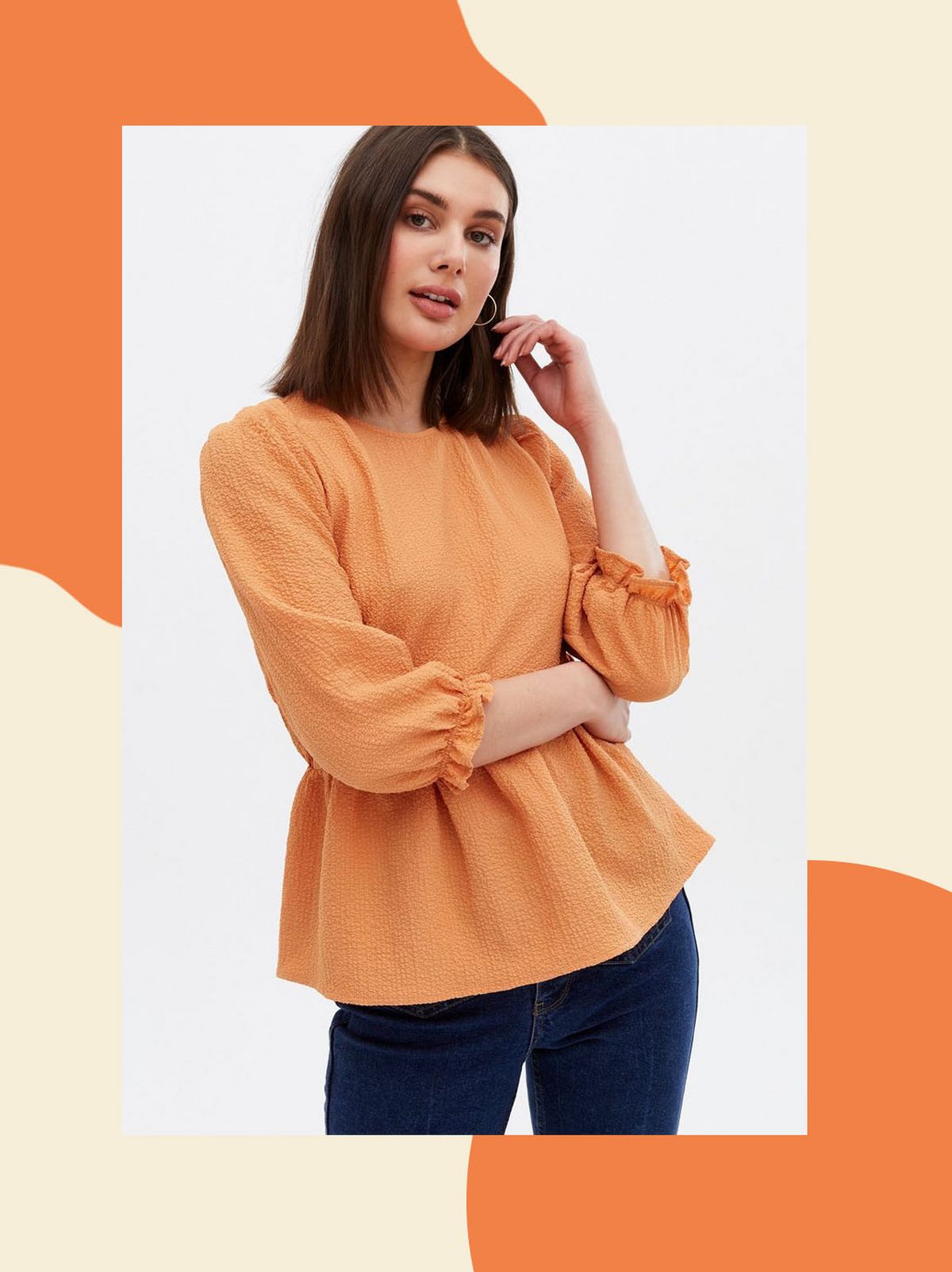 Woman wearing a bright orange tie back peplum blouse