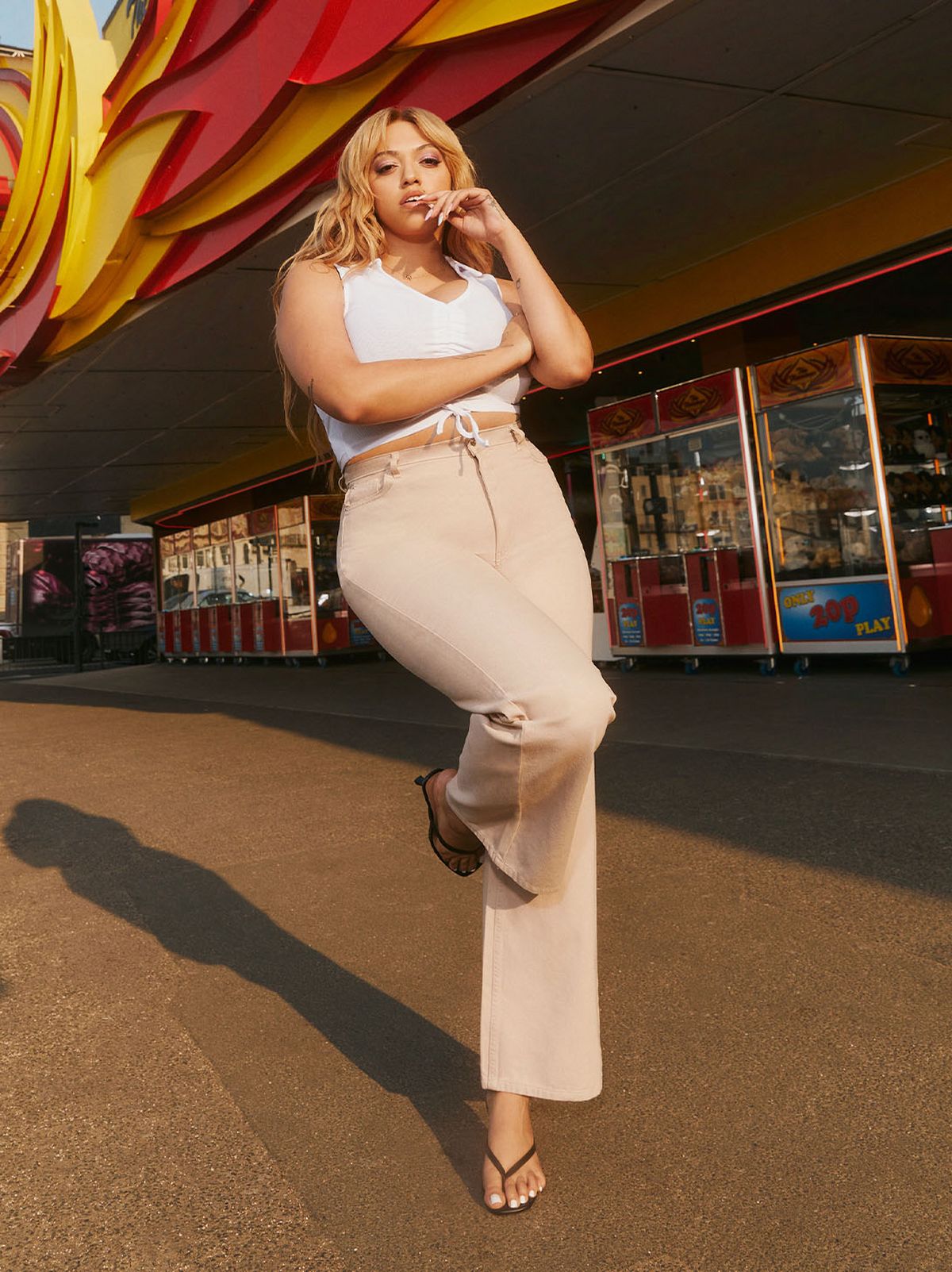 Mahalia wearing cream wide leg jeans and white crop top