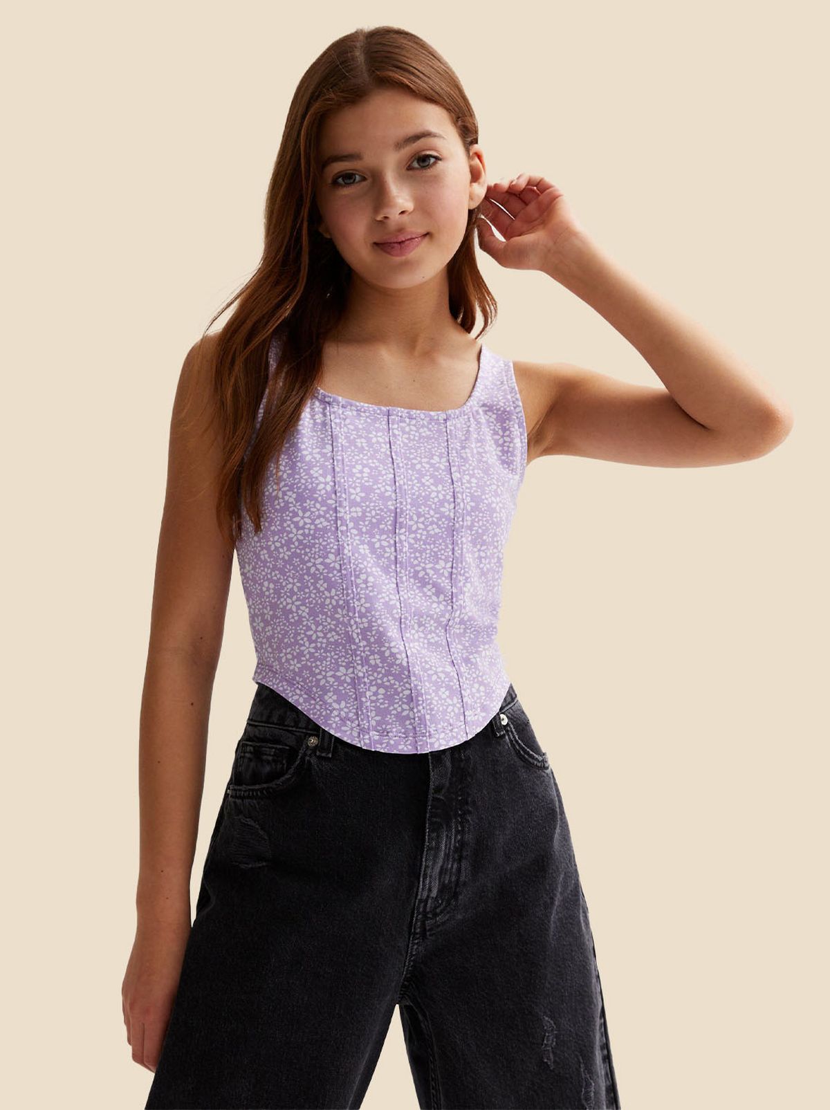 Girl wearing a purple floral corset top​