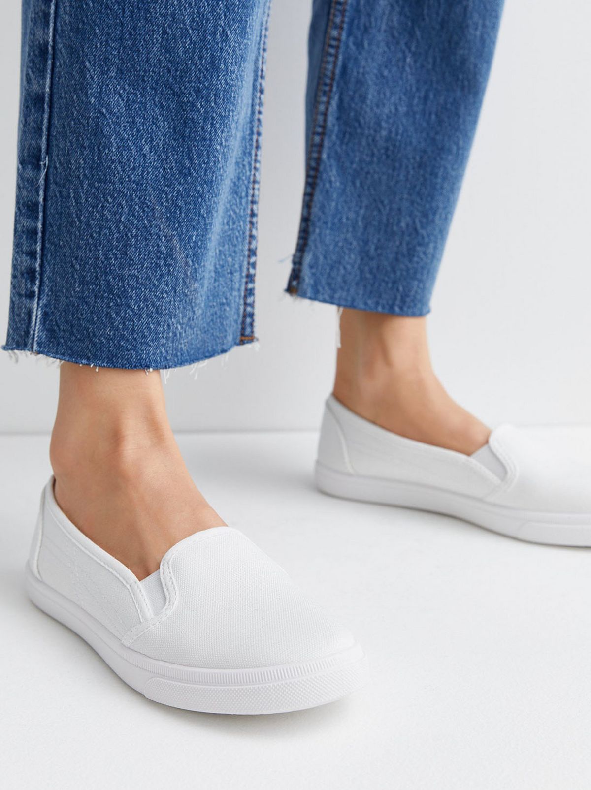 White canvas slip on trainers