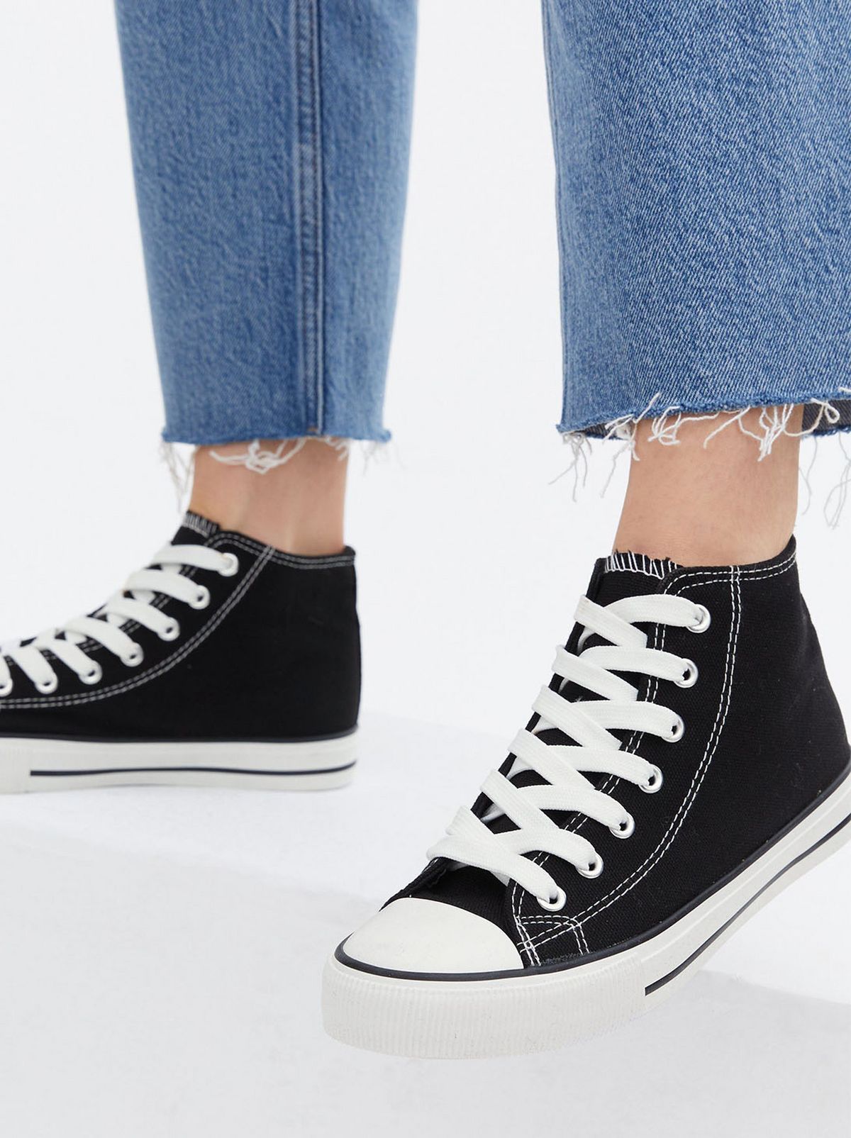 Black canvas high top trainers