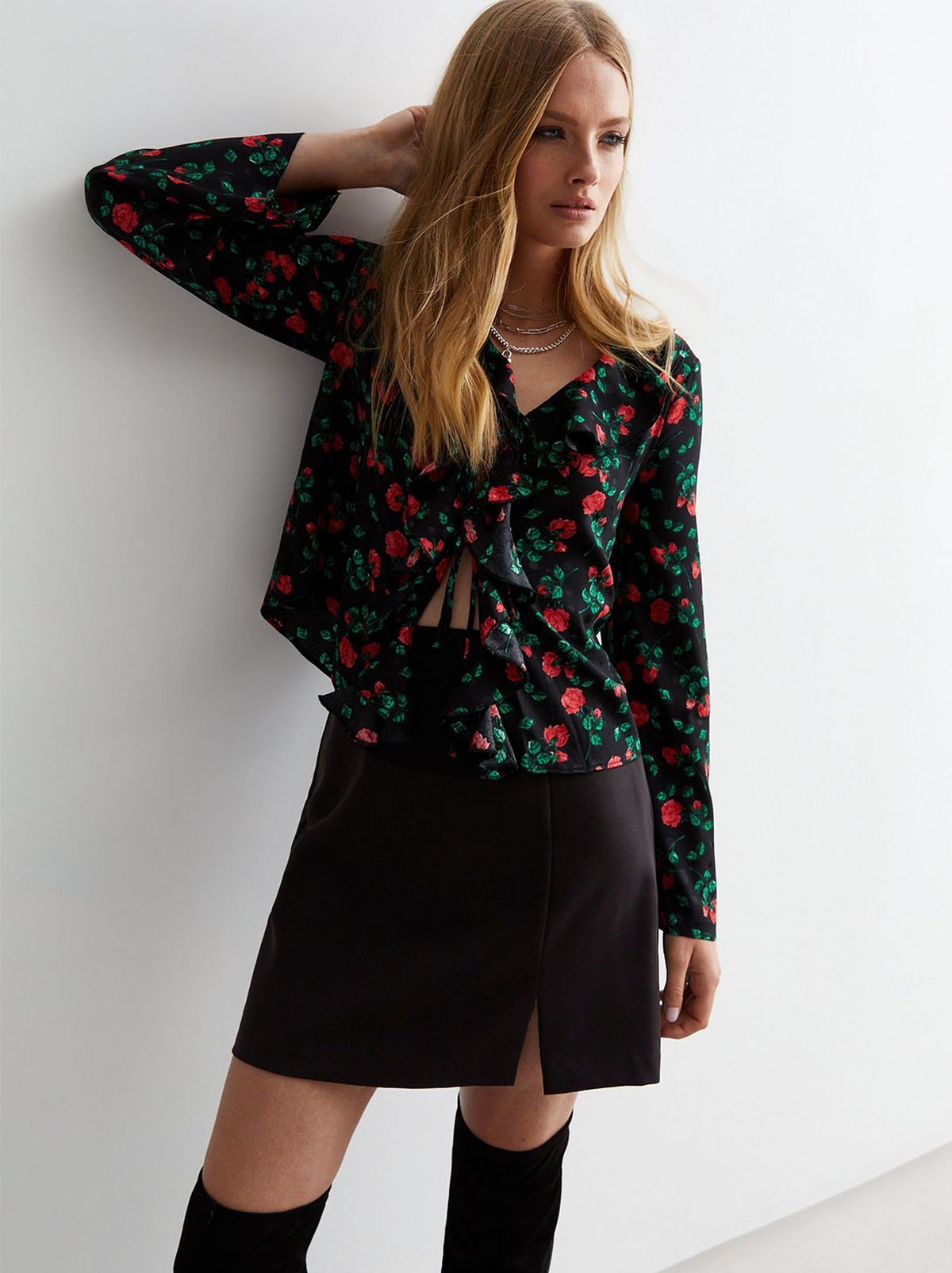 A model wearing a black floral crop top. Shop now