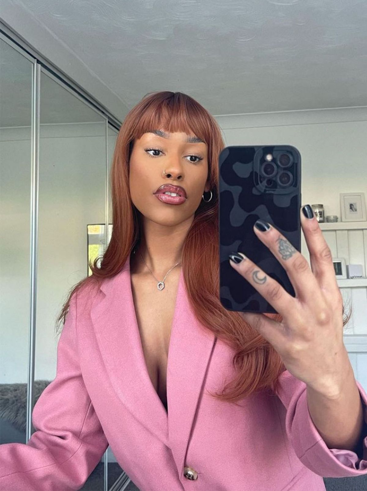 New Looker Jasmine is taking a selfie in a bedroom while wearing a muted pink blazer dress	