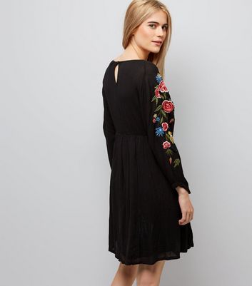 black dress with embroidered sleeves