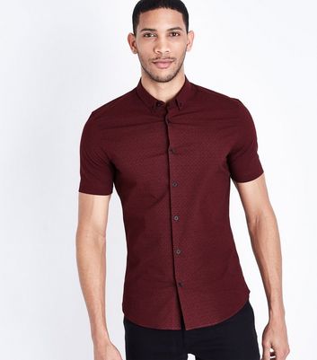 maroon shirt and black jeans