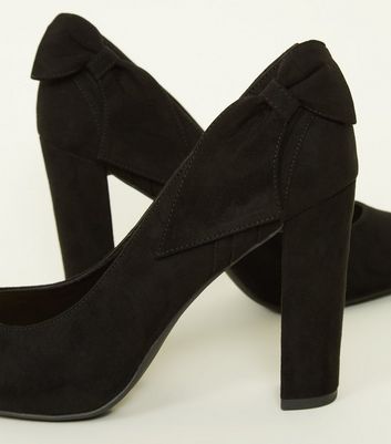 black heels with bow on back
