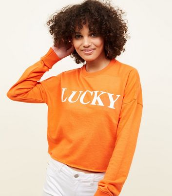 cropped orange sweatshirt