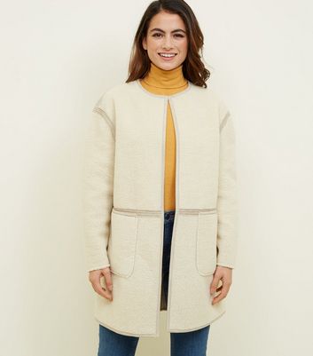 cream collarless coat