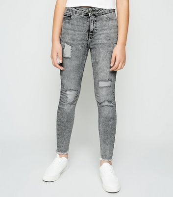 grey jeans with rips