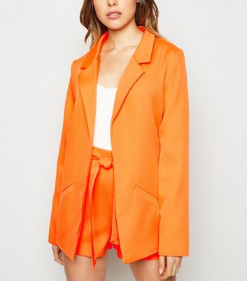 orange blazer and shorts