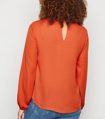 orange high neck blouse
