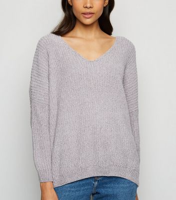 grey jumper and blue jeans