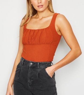 rust colored sleeveless top