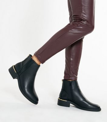 black boots with brown trim