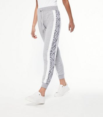 grey joggers with white stripe