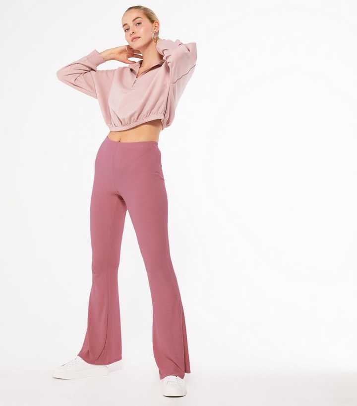 https://media2.newlookassets.com/i/newlook/668922972/womens/clothing/trousers/pink-ribbed-jersey-flared-trousers.jpg?strip=true&qlt=50&w=720