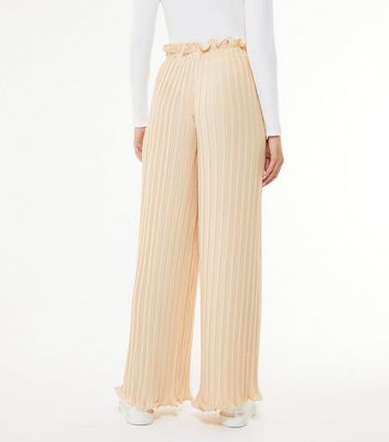 white pleated wide leg trousers