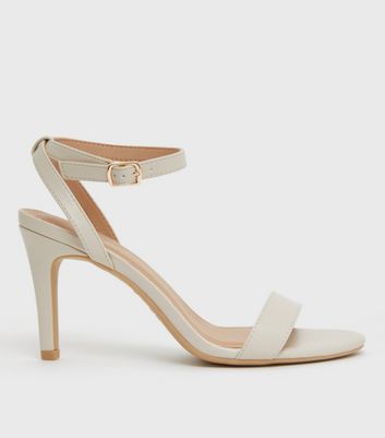 Ankle strap mid heel sandals in off-white leather . PURA LOPEZ