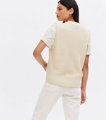 Click to view product details and reviews for Off White Ribbed Knit Button Long Sleeveless Vest New Look.