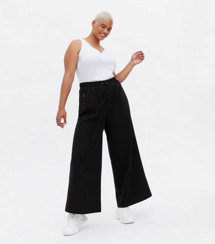 WIDE-LEG TROUSERS WITH ZIPS - Black