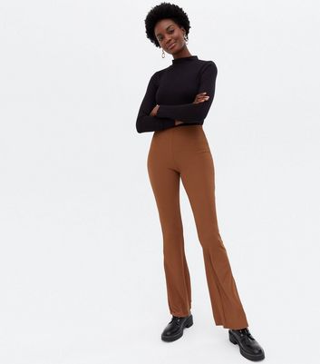 Click to view product details and reviews for Rust Ribbed High Waist Flared Trousers New Look.