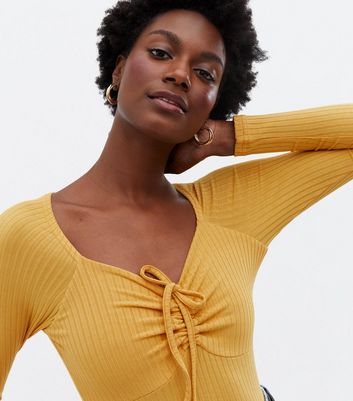mustard yellow long sleeve bodysuit