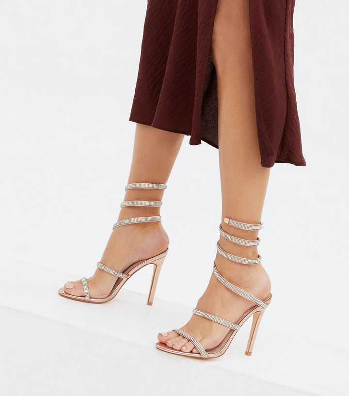 https://media2.newlookassets.com/i/newlook/812511294M1/womens/footwear/shoes/rose-gold-diamante-spiral-strap-stiletto-heel-sandals.jpg?strip=true&qlt=50&w=720