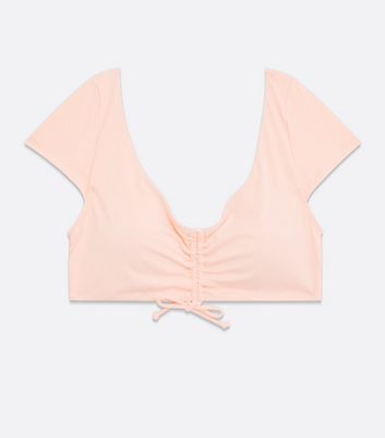 Click to view product details and reviews for Pink Ruched Tie Front Crop Bikini Top New Look.