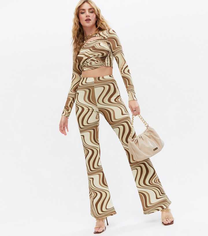 https://media2.newlookassets.com/i/newlook/813266616/womens/clothing/trousers/pink-vanilla-stone-marble-swirl-slinky-flared-trousers.jpg?strip=true&qlt=50&w=720