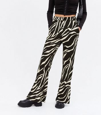 Click to view product details and reviews for Black Zebra Print Flared Trousers New Look.