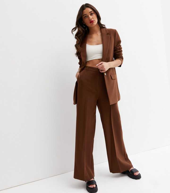 https://media2.newlookassets.com/i/newlook/817958327/womens/clothing/trousers/brown-high-waist-wide-leg-trousers.jpg?strip=true&qlt=50&w=720