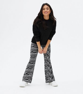 Click to view product details and reviews for Petite Black Zebra Print Jersey Flared Trousers New Look.